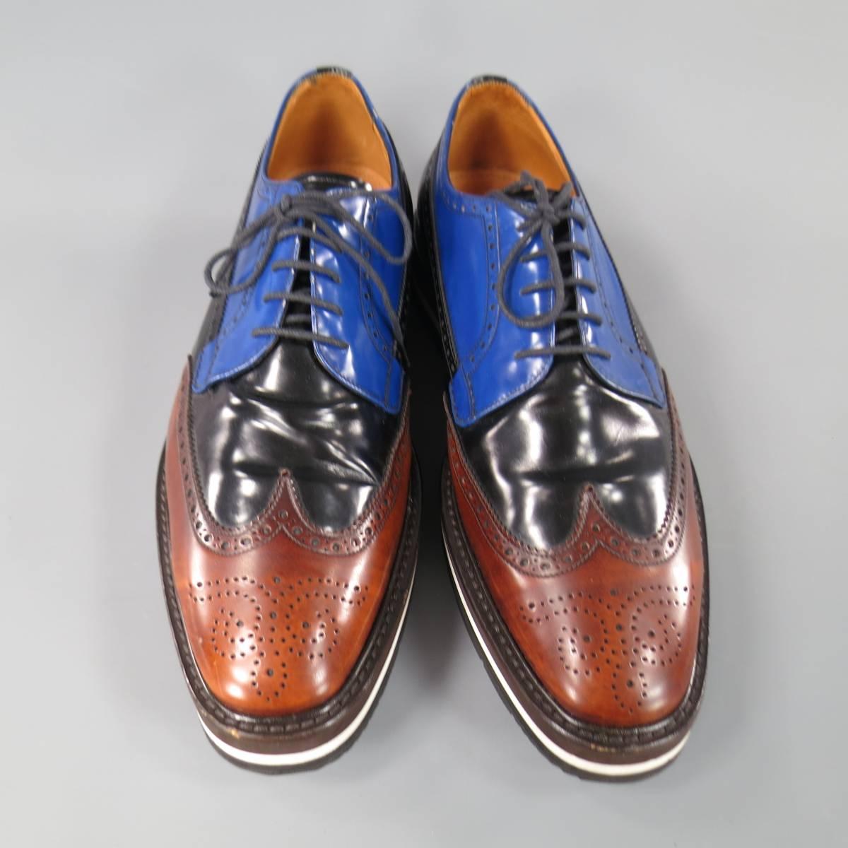 Iconic PRADA Spring 2011 lace up brogues in blue, black, and brown color block leather with wingtip toe, perforated details throughout, and striped platform sole. Made in Italy. Retails at $1150.00.

Excellent Pre-Owned Condition.
Marked: 10.5
