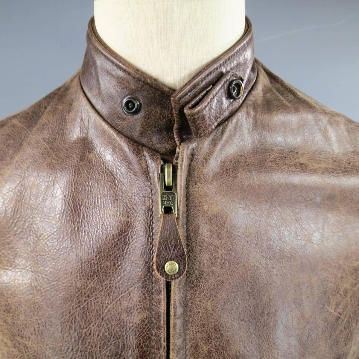 Classic vintage SCHOTT biker jacket comes in distressed brown leather and features a band collar with snap tab, zip up front, double slit zip pockets, and satin lining. Made in USA.
 
Excellent Pre-Owned Condition.
Marked: S
 
Measurements:
