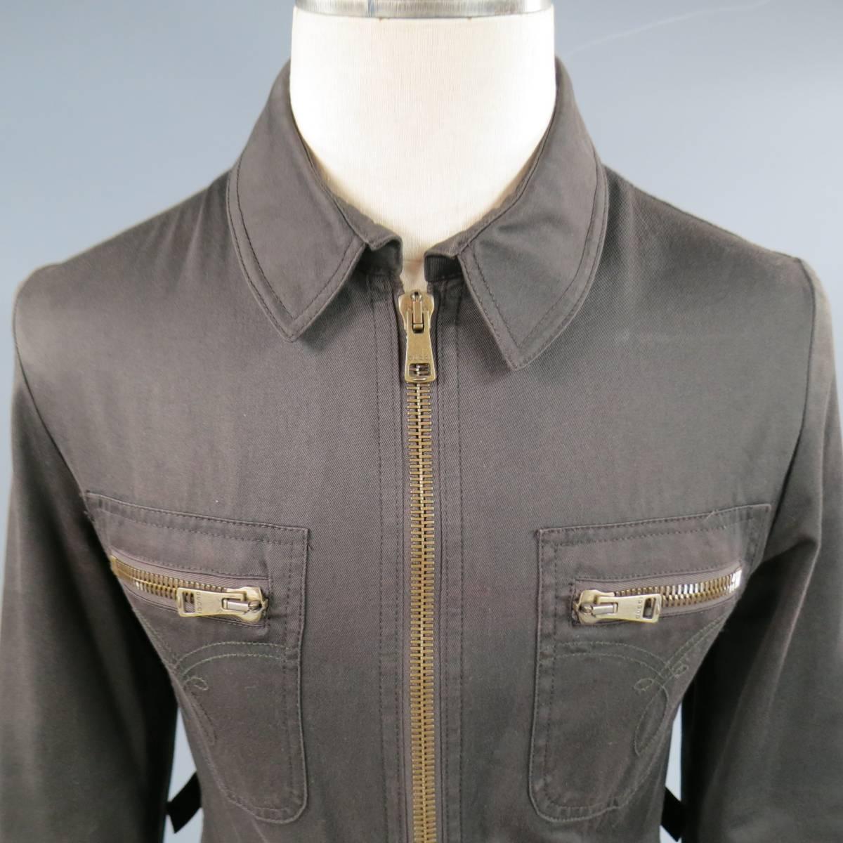 This luxury work style jacket by GUCCI comes in a light weight brown cotton twill and features a pointed collar, oversized gold tone zip closure, c=double patch pockets with embroidery, zip pockets, and back tabs. Fading throughout. Made in Italy.
