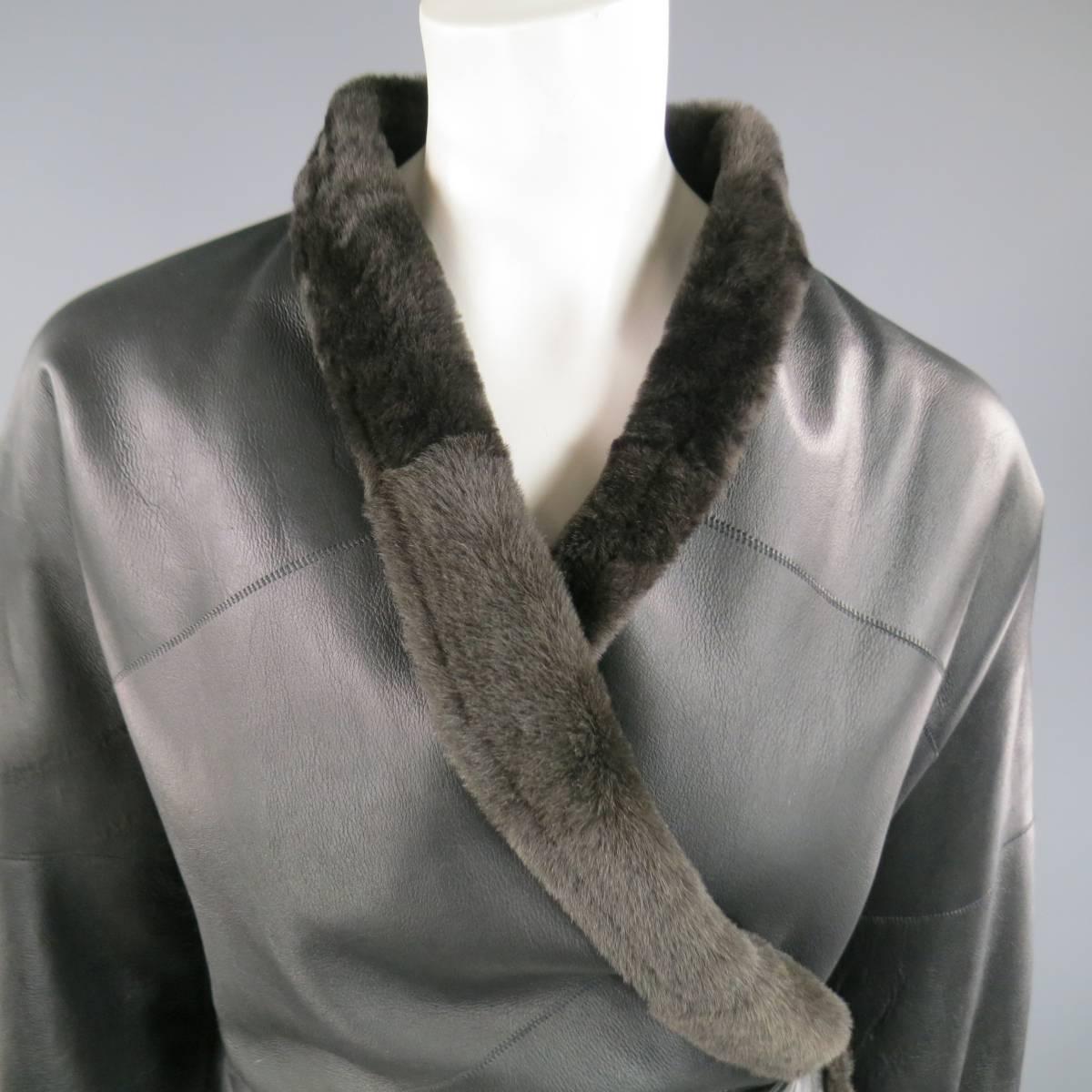 This fabulous MAX MARA jacket comes in black leather shearing with brown fur and features a band lapel, cuffed sleeves, and wrap and tie closure. Made in Italy.
 
Excellent Pre-Owned Condition.
Marked: US 2
 
Measurements:
 
Shoulder: 18