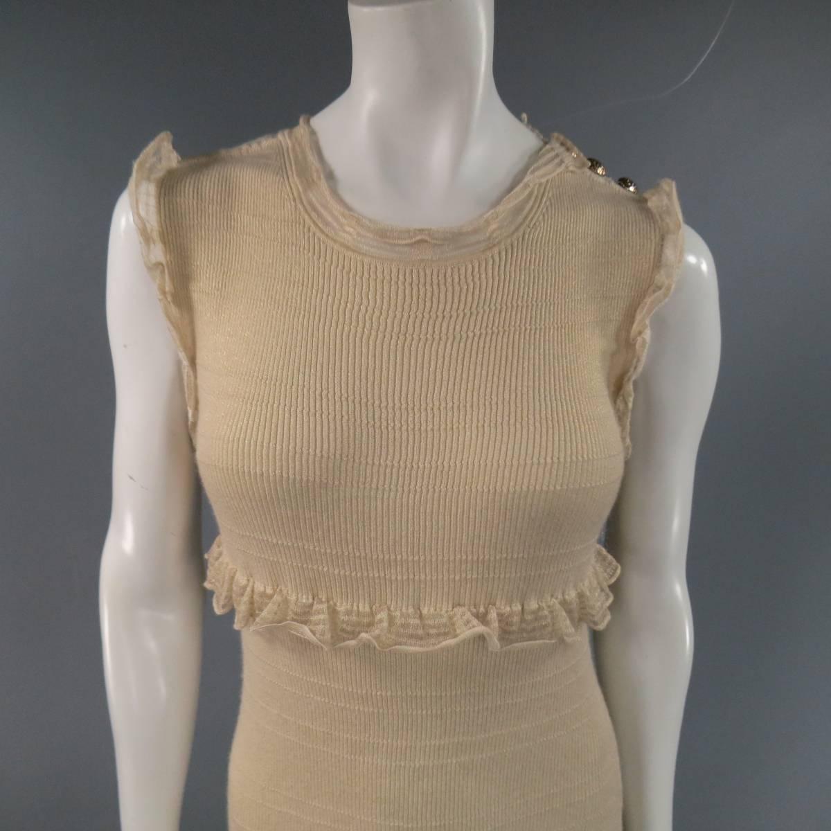 This gorgeous CHANEL sleeveless cocktail dress comes in a light weight champagne gold cashmere silk blend sparkle knit and features a crew neck with sheer trim, empire waist, metallic button shoulder, and sheer ruffled trim on shoulder and hem. Lots