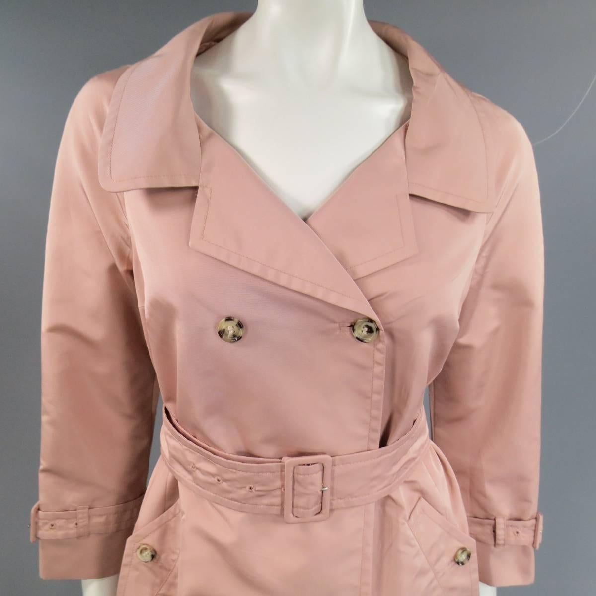 This fabulous PRADA trench coat comes in a dusty rose pink silk blend taffeta and features a portrait collar with lapel, double breasted button up closure, belted sleeves, and a line skirt. Made in Italy.
 
Excellent Pre-Owned Condition.
Marked: