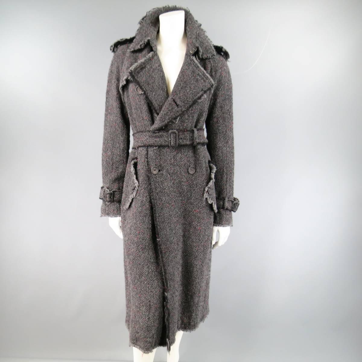 This gorgeous JUNYA WATANABE COMME des GARCONS trench coat comes in a charcoal grey tweed with hints of red and features a pointed collar, epaulets, double breasted button up closure, storm flap, double flap pockets, belted cuffs, matching fabric