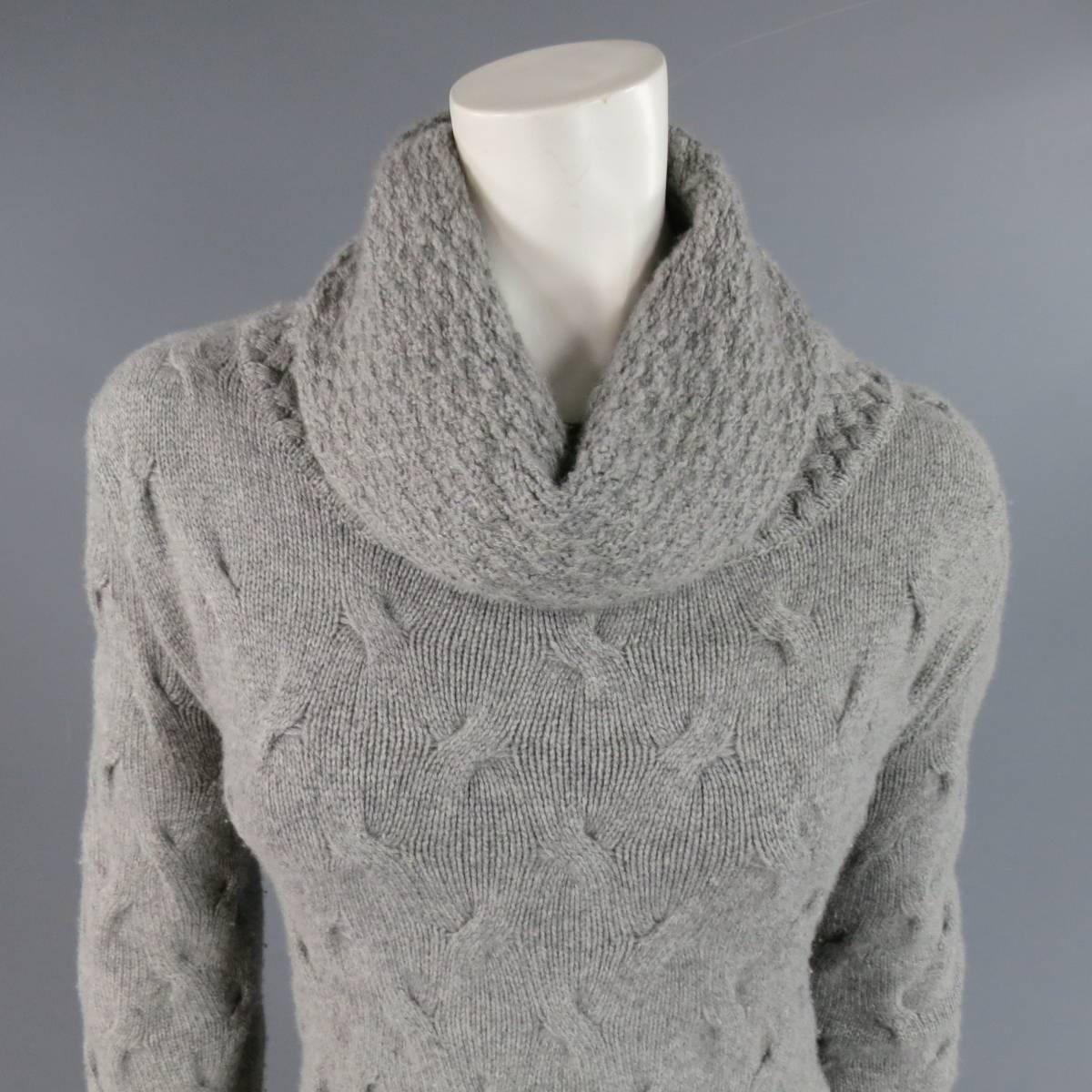 Oversized sweater dress by LORO PIANA in gray cashmere knit with cable like texture featuring a cowl neck and ribbed trim. Made in Italy.
 
Good Pre-Owned Condition.
Marked: IT 44
 
Measurements:
 
Shoulder: 17 in.
Bust: 44 in.
Waist: 38