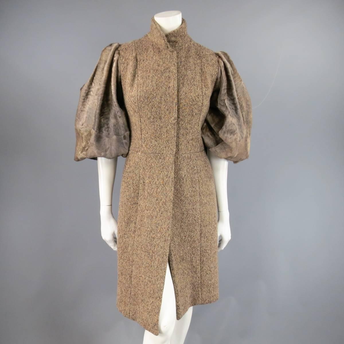 Gorgeous brown tweed winter coat by PETROU in a taupe brown tweed featuring a high collar, four lace covered snap closure, A-line skirt, organza overlay satin lining, and brown cowhide balloon sleeves.
 
Excellent Pre-Owned Condition.
