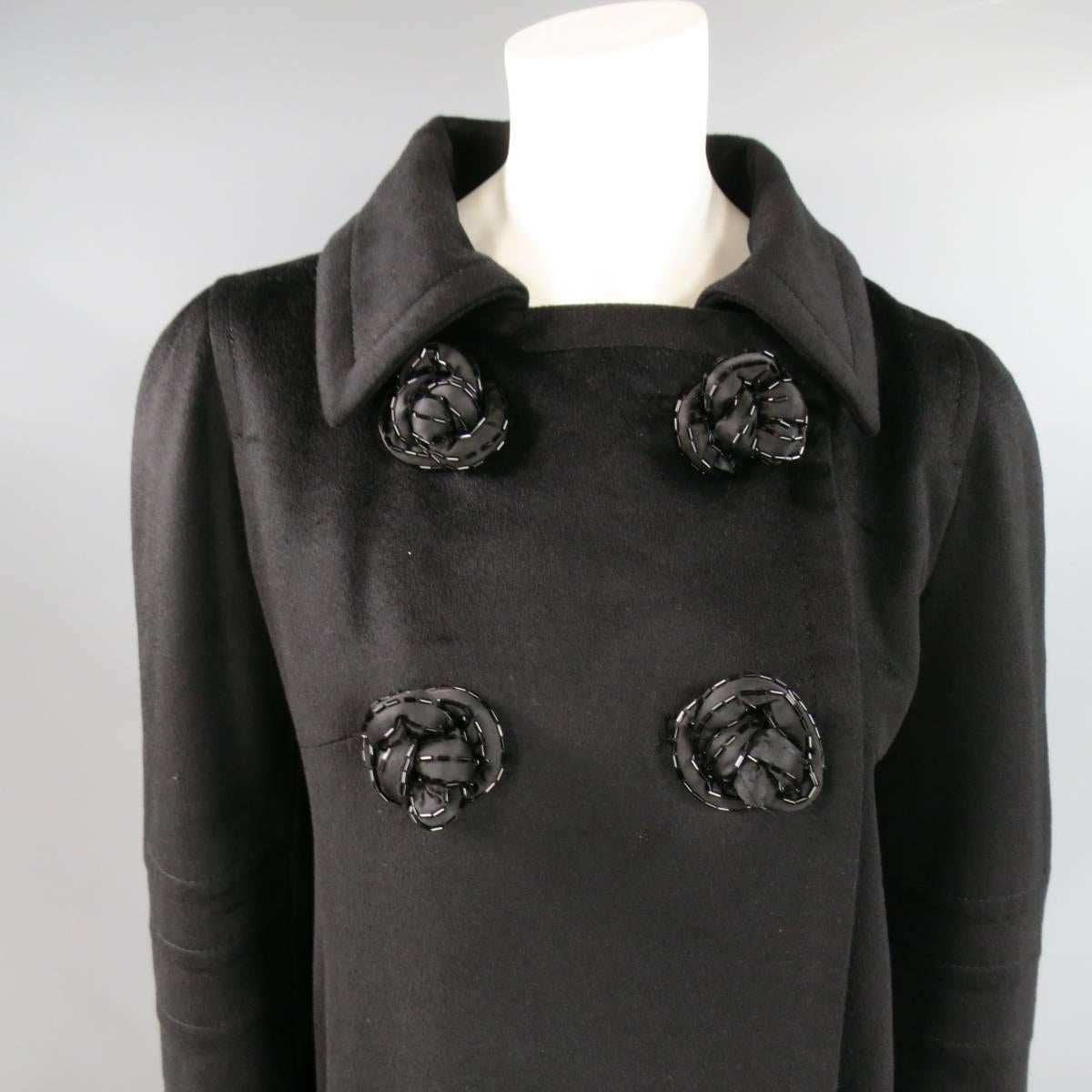 Fabulous JEAN-LOUIS SCHERRER coat in black cashmere blend fabric with a wide, pointed collar, double patch pockets, double breasted two snap closure at top, pleated back, and beaded rose apliques. Made in France.
 
Good Pre-Owned Condition.
