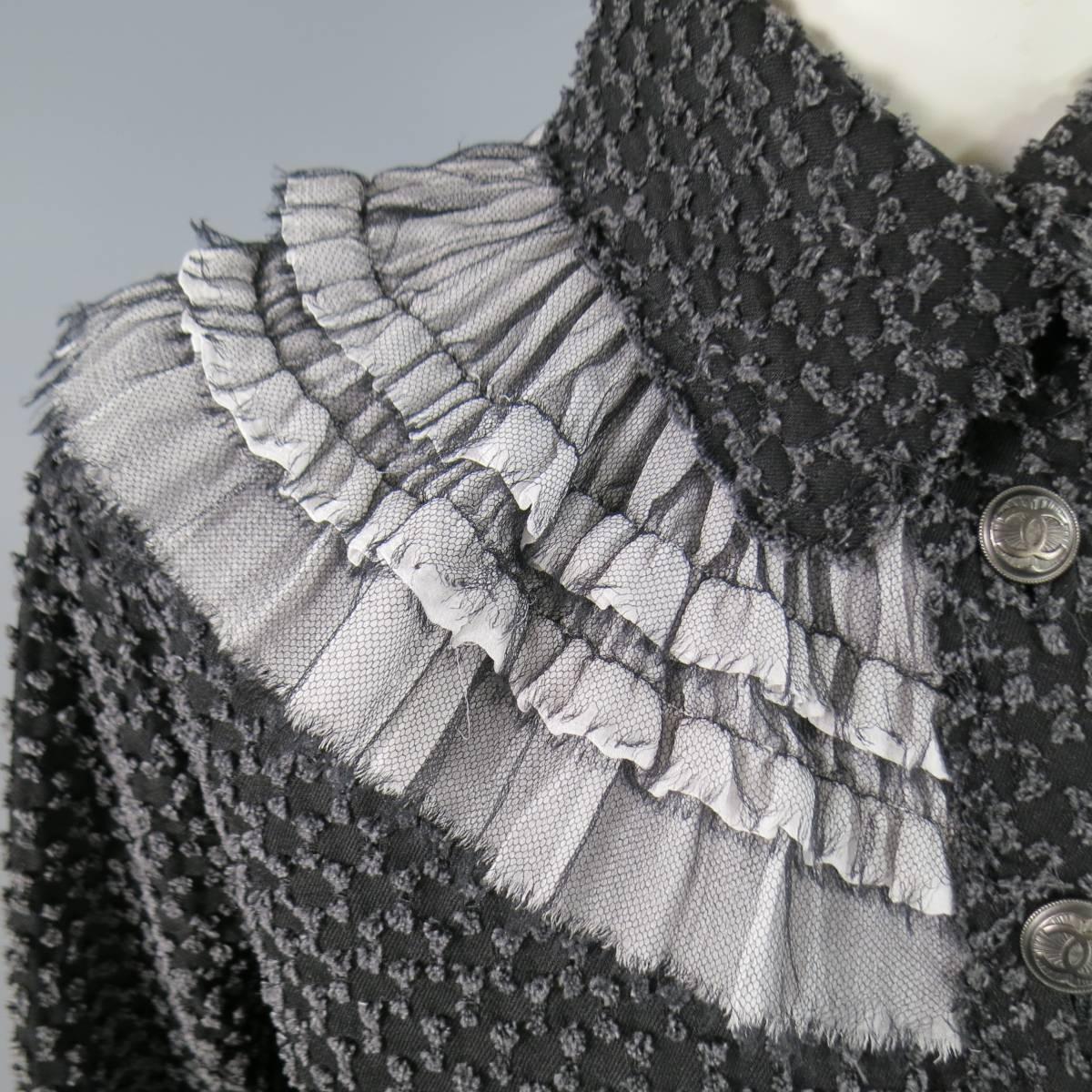 This gorgeous CHANEL jacket comes in an all over distressed patter black denim and features a pointed collar, gunmetal CC logo buttons, double patch pockets, and beautiful white raw edge ruffles with black tulle overlay. A couture interpretation of