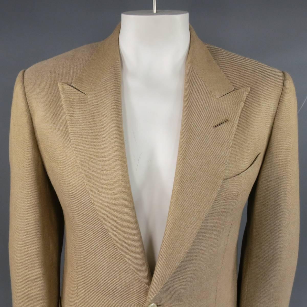 Men's TOM FORD Sport Coat consists of linen/silk material in a khaki color tone. Designed in a 2-button front, peak-lapel collar, top pocket square and bottom patch pockets. Detailed with 5-button cuffs, double back vent, woven pattern and