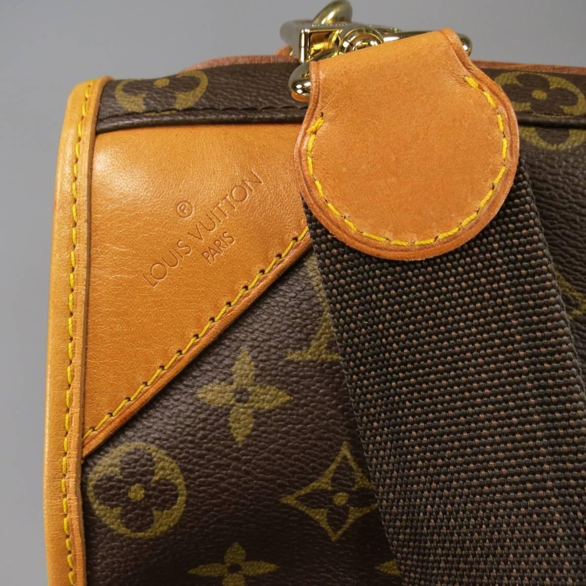 Classic brown garment bag circa 2005 by LOUIS VUITTON. In signature monogram brown printed canvas, featuring tan leather details, top handles, detachable strap, and internal garment bag. A suitcase/garment classic bag . Luggage tag included. Wear
