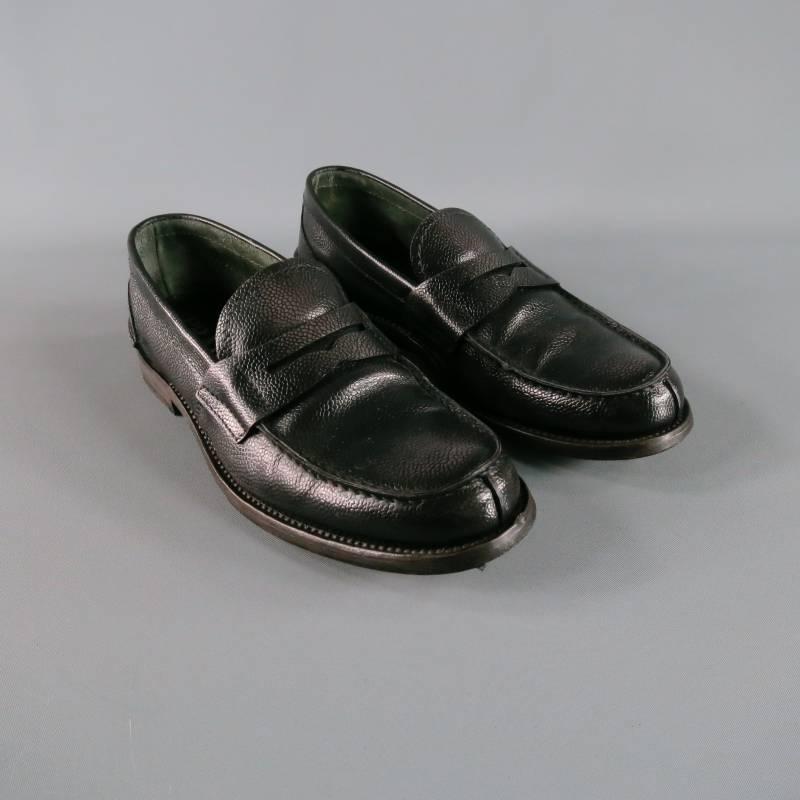Classy PRADA slip on loafer in bison leather; pebbled texture in black tone with a subtly distressed polish style.  Vertical front seam with horizontal back heel seam with tone on tone stitching. Comfortable suede interior.  Wooden stack toe with