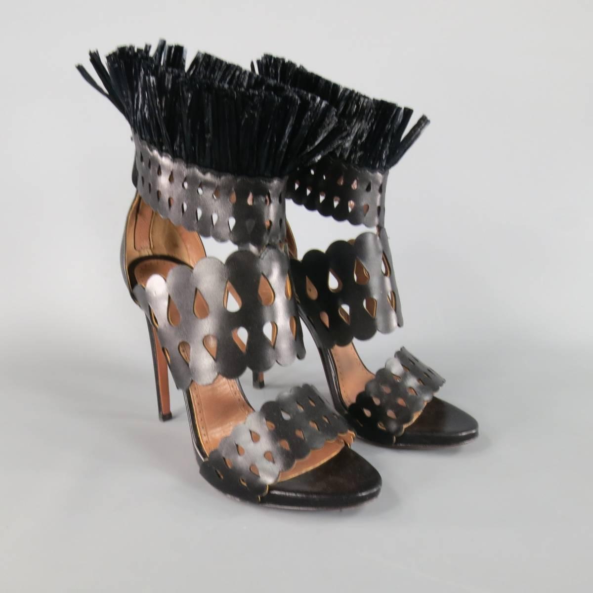 Fabulous ALAIA high heeled sandals in smooth black leather featuring thick, rounded cutout straps, low platform, and stand up fringe ankle accent. Made in Italy.
 
Excellent Pre-Owned Condition.
Marked: IT 38.5
 
Heel: 4.75 in.
