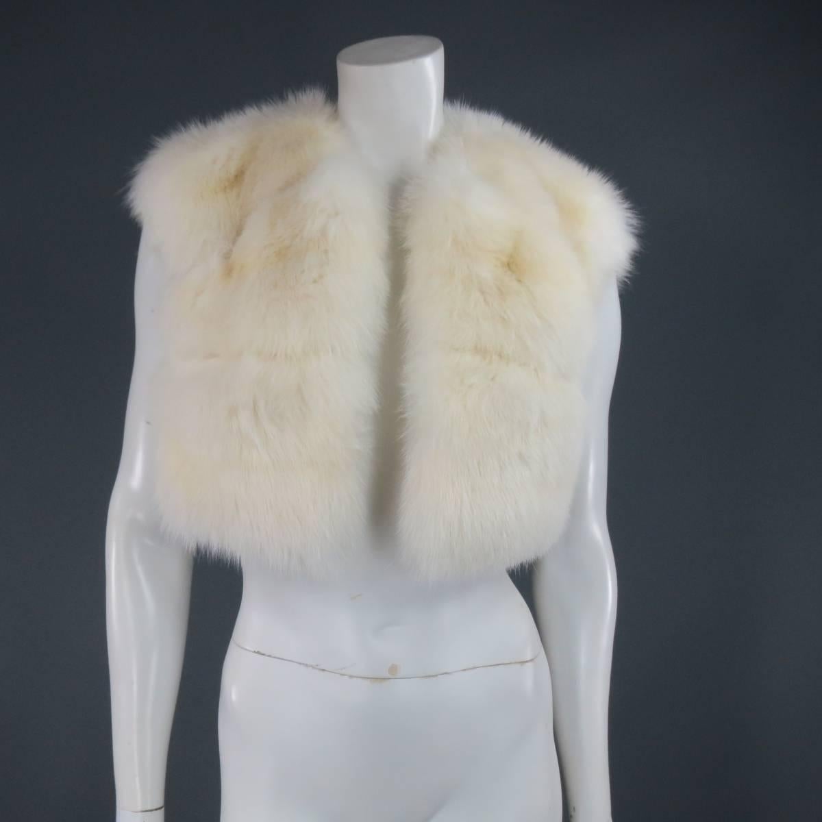 Classic cropped vest by DENISS BASSO in creamy, off white, soft sable fur with a high, round neck, open front, and silk lining. Made in USA.
 
Excellent Pre-Owned Condition.
 
Measurements:
 
Shoulder: 16 in.
Bust: 36 in.
Length: 17 in.