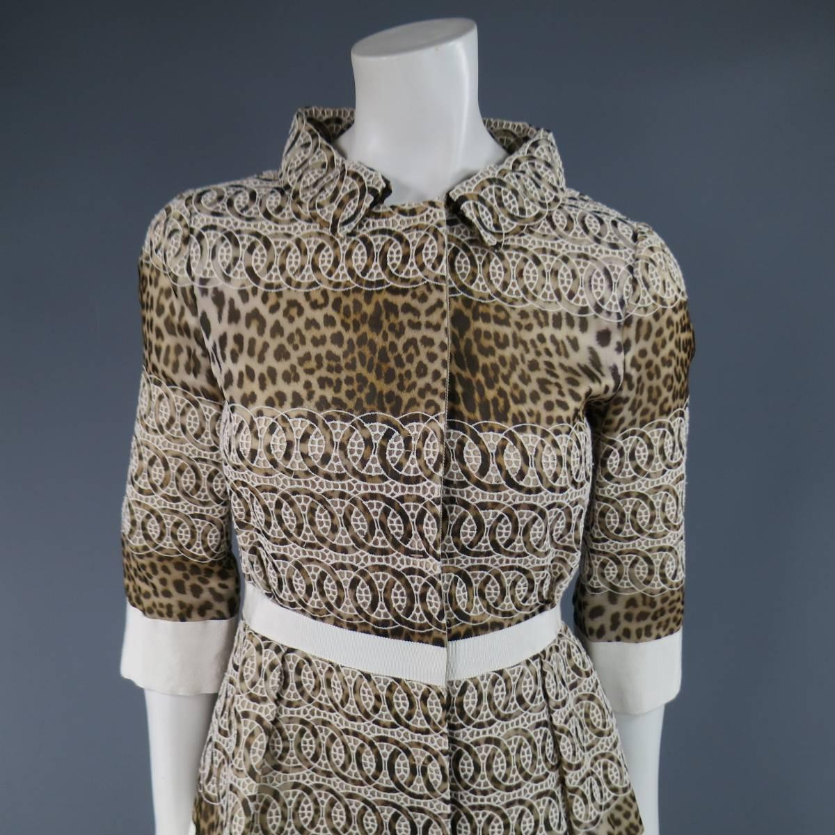 This stunning GIAMBATTISTA VALLI coat dress comes in a light taupe beige cheetah leopard print silk with panel stripes of embroidery and features light beige ribbon trim, pointed, embroidered collar, 3/4 sleeves, hidden placket snap closure, and