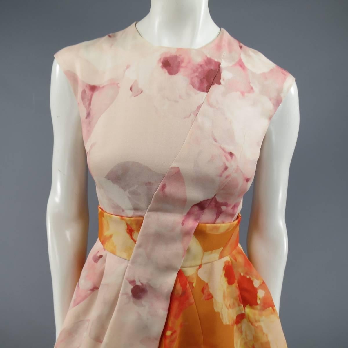 This gorgeous CHRISTIAN DIOR sleeveless cocktail dress comes in a pink and orange watercolor floral print silk wool fabric and features a high round neckline, orange belted waist with pink overlay panel, and pleated A line skirt with crinoline and