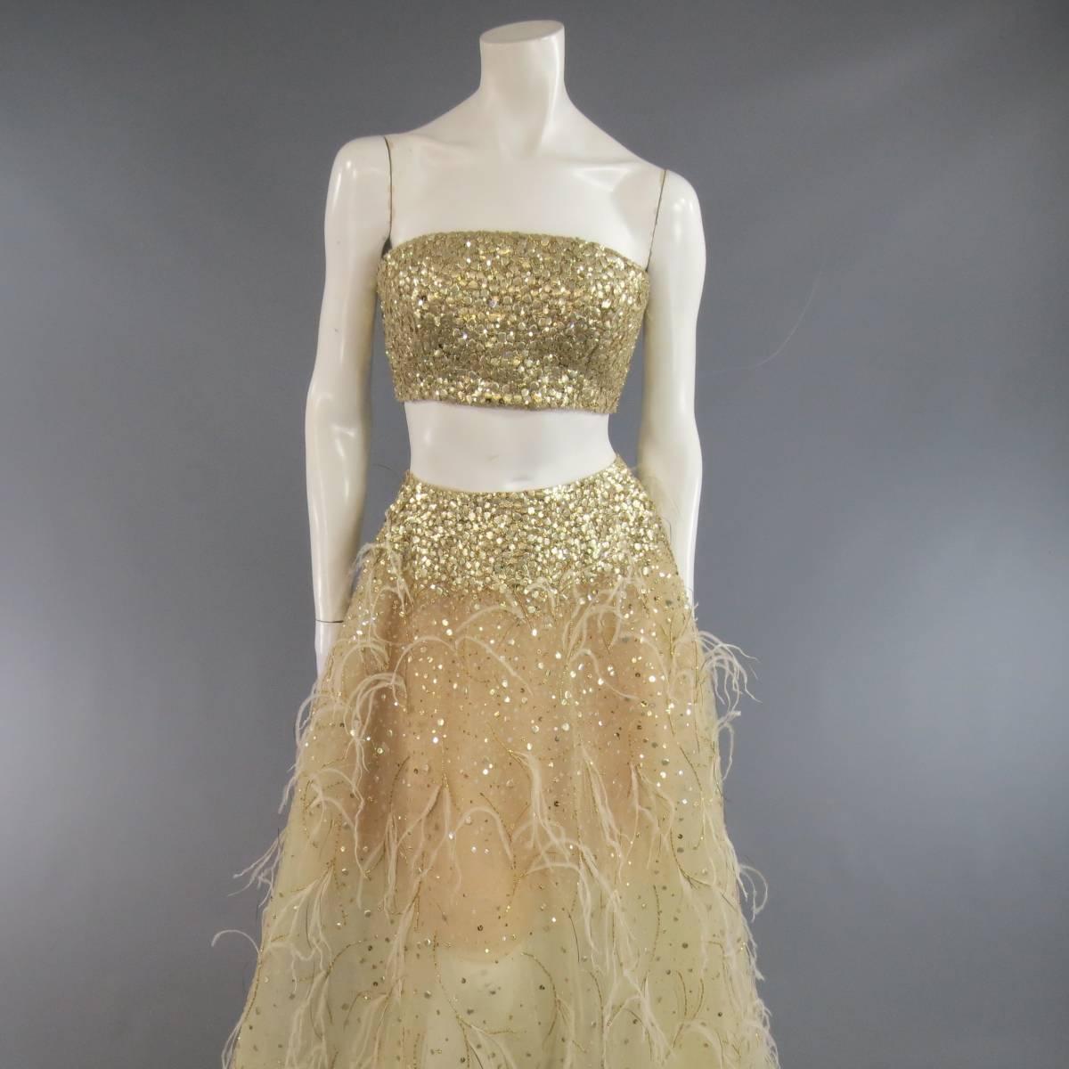 This fabulous OSCAR DE LA RENTA Spring 2015 collection evening look includes a full length gold tulle skirt embellished with clear and gold sequin, ostrich feathers, and gradient beadwork with a matching gold sequin bralet bustier. Made in the