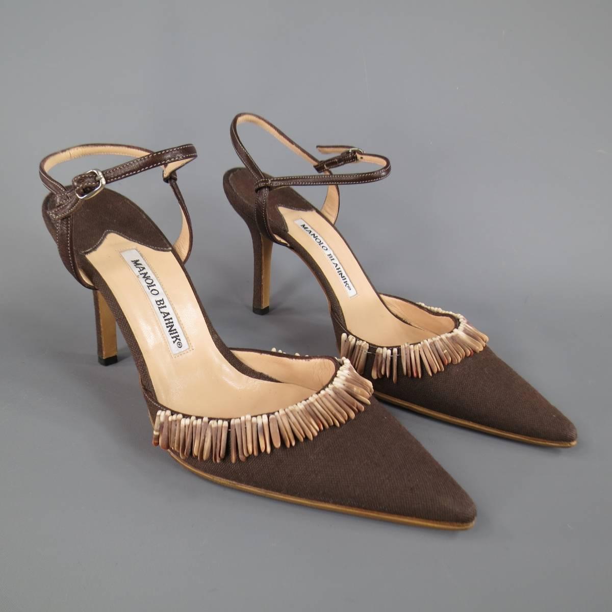 Lovely MANOLO BLAHNIK pumps in brown canvas with a leather ankle harness strap, covered stiletto heel, and pointed toe with sea shell embellishment. Resoled. Made in Italy.
 
Excellent Pre-Owned Condition.
Marked: IT 38
 
Heel: 4 in.