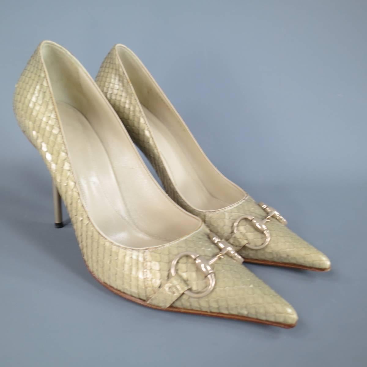 These fabulous GUCCI pumps come in a light muted minty beige snakeskin leather and feature a pointed toe with silver tone horsebit detail and a metal spike heel. Made in Italy.
Retails at $880.00.

Excellent Pre-Owned Condition.
Marked: US 9.5