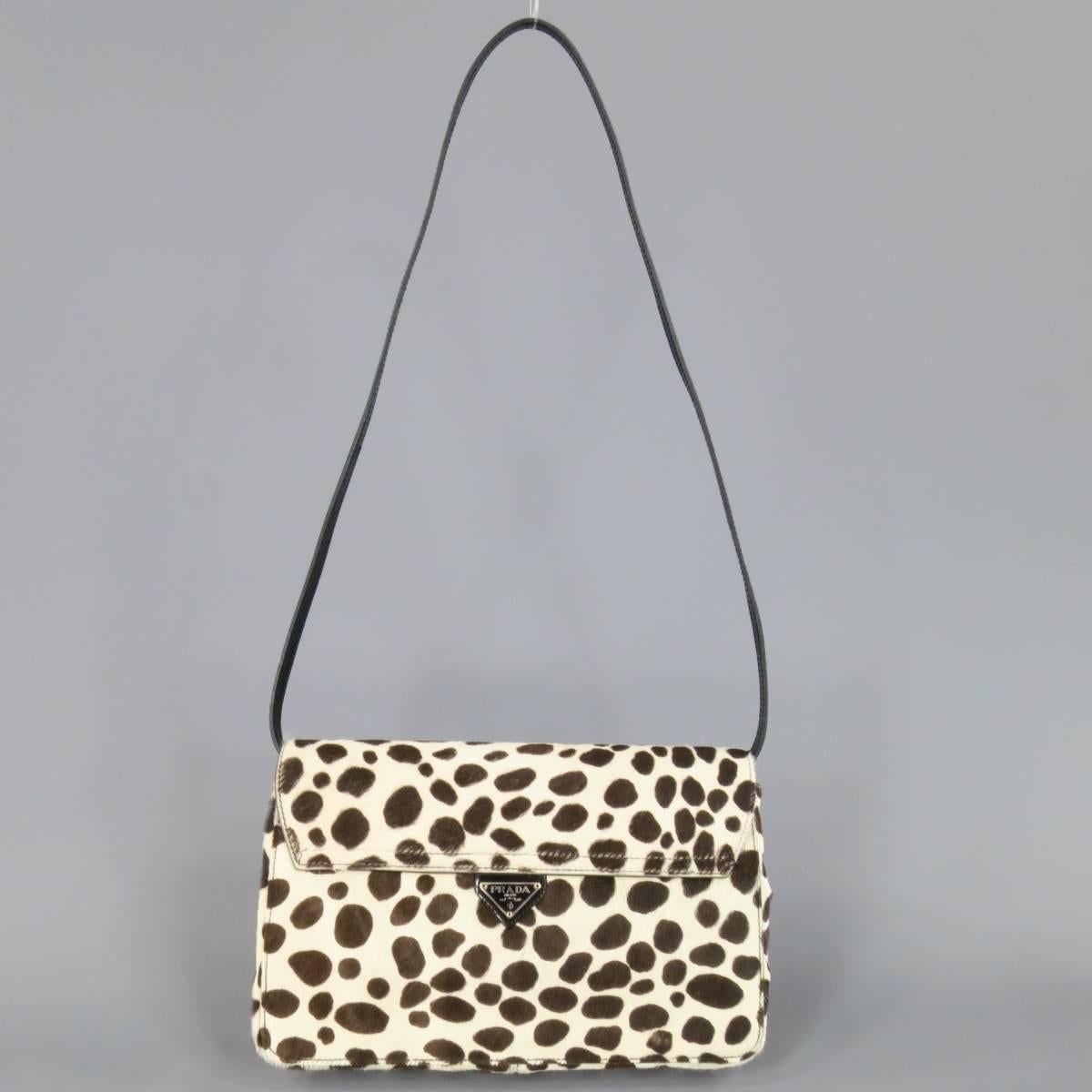 Lovely PRADA clutch in cream and brown spotted anuimal print pony hair leather featuring an enamel logo, envelope snap closure, and removable shoulder strap.Minor discoloration under flap. Made in Italy.
 
Excellent Pre-Owned Condition.
