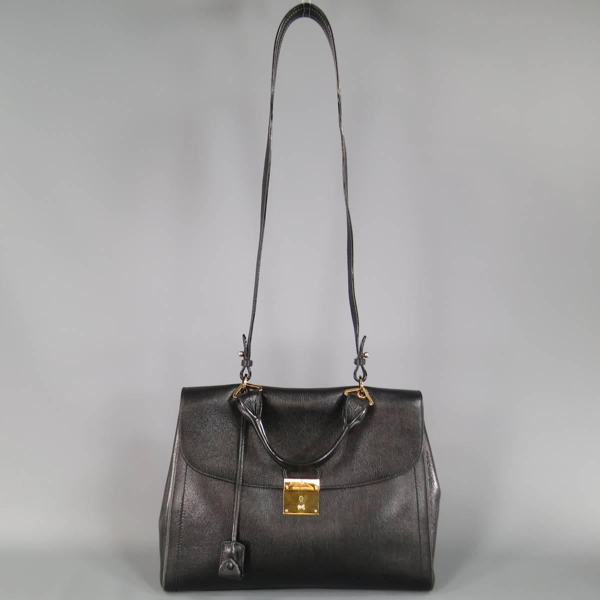 This gorgeous MARC JACOBS satchel handbag comes in  textured black leather and features a gold tone lock clasp closure, tan piping on sides, top handle, clochette with lock, and optional shoulder strap. Made in Italy.
Retails at $1495.00.

Brand