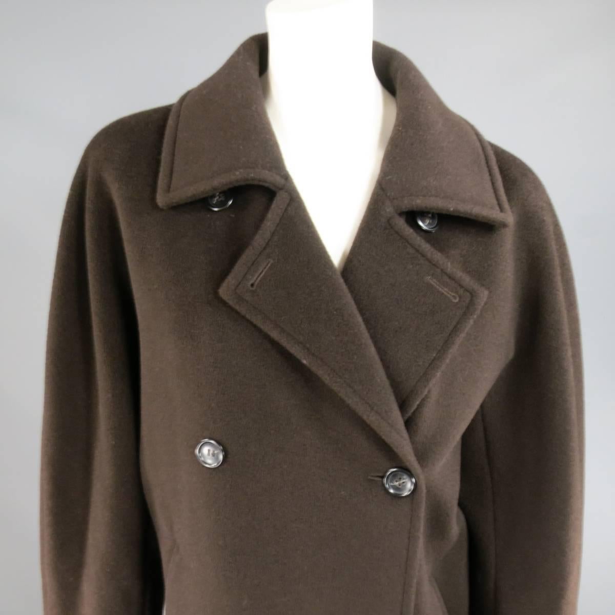 This gorgeous vintage MAX MARA coat comes in a chocolate brown virgin wool fleece fabric and features a large, pointed collar, round seamless shoulder, double breasted button up closure, oversized silhouette, and double slanted slit pockets. Made in