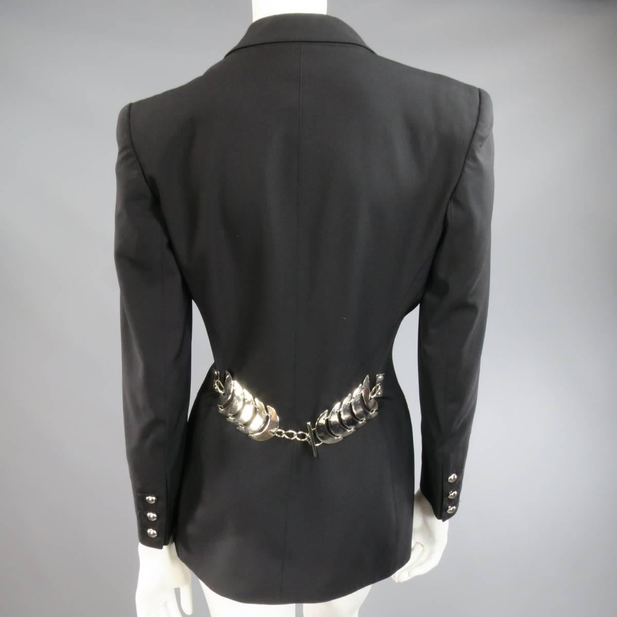 This fabulous vintage CLAUDE MONTANA jacket comes in a light weight black wool and features a peak lapel, Strong padded shoulder, single shiny silver tone button, double faux slit pockets, functional button sleeves, tailored hourglass silhouette,