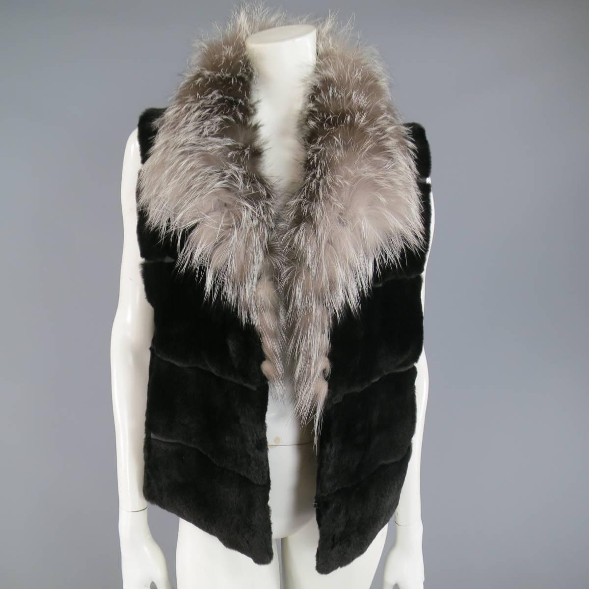 This gorgeous vintage ANDRIANA FURS vest features a soft black velvety mink fur stripe patched body with hook & eye closures, and a silver fox fur collar.
 
Good Pre-Owned Condition.
No Size Tag.
 
Measurements:
 
Shoulder: 16 in.
Bust: 38