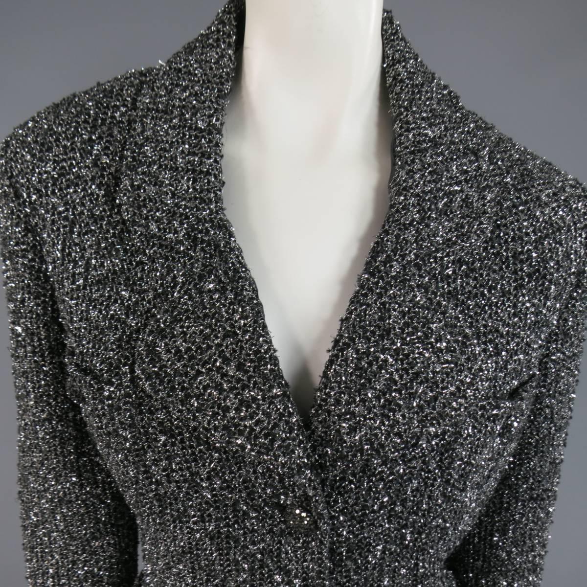 This gorgeous ST. JOHN CAVIAR statement jacket comes in black and silver metallic sparkle textured knit and features a rounded lapel, four patch pockets with gunmetal crystal embellished buttons, three button closure, and satin lining. Small tear in