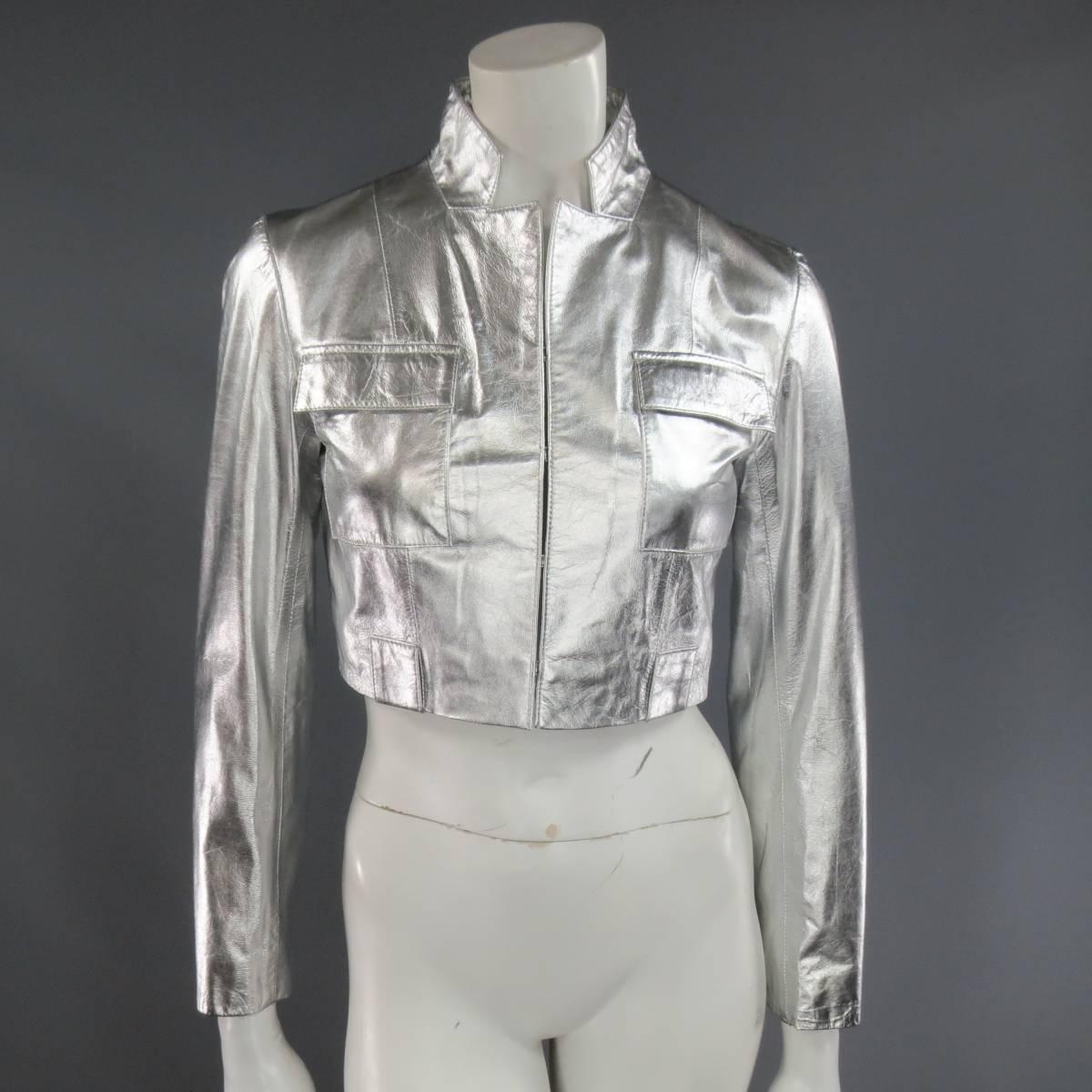 This fabulous RAOUL Fall 2012 collection cropped jacket comes in light weight metallic silver leather and features a slim lapel, hood and eye closures, double breast patch flap pockets, and belt loops.
 
Good Pre-Owned Condition.
Marked: S

