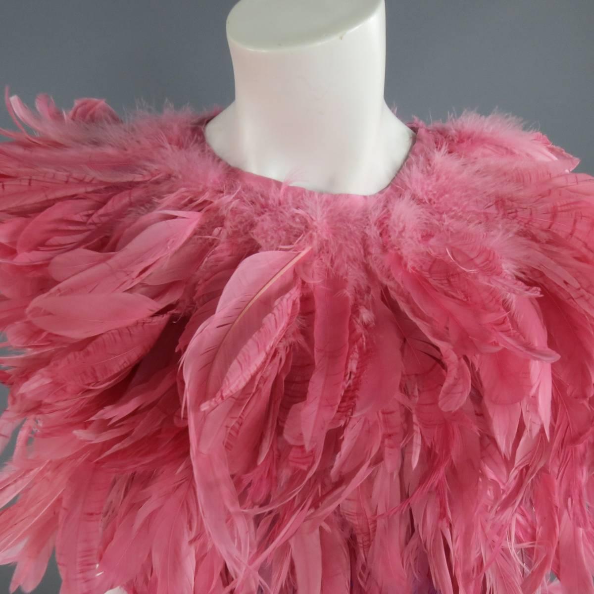 This fabulous MOSCHINO Spring 2016 cocktail dress features a dramatic pink feather neckline, pink and purple rayon body with velvet band, and purple feathered skirt with pink feather layer. Tag Removed but included. Made in Italy.
 
Excellent