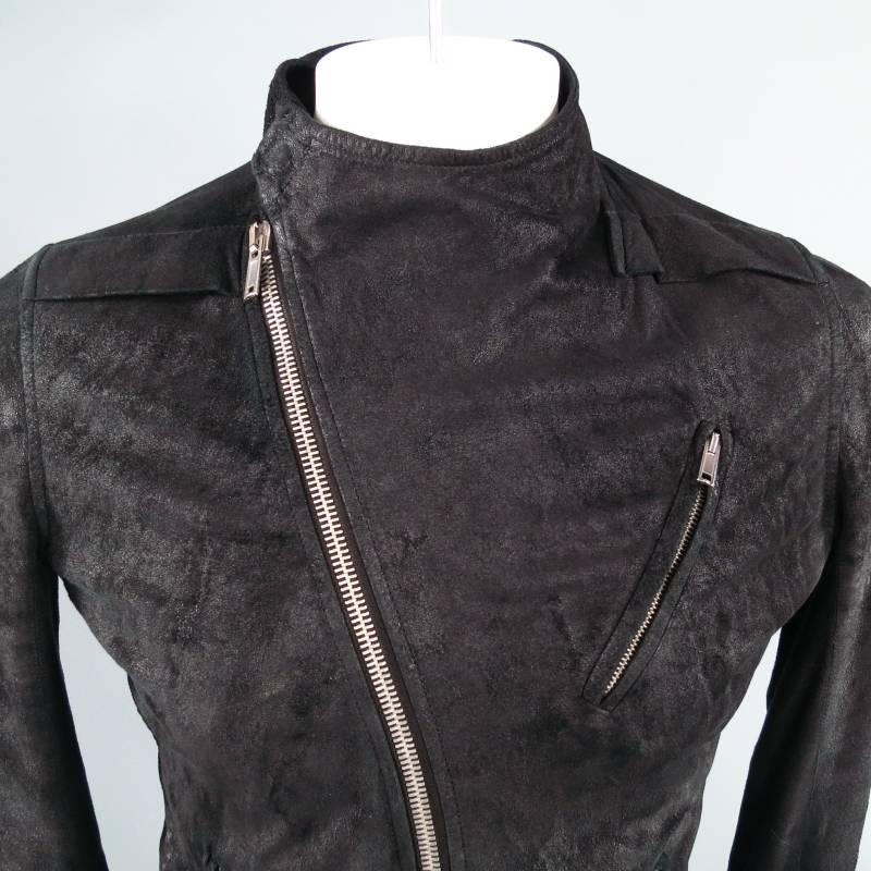 Rick Owens Jacket consists of 100% Lamb Skin leather in a black color tone. Designed with asymmetrical zipper front that features silver hardware, multi-inseam zipper pockets by hem and chest, tone-on-tone stitching throughout body with open panel