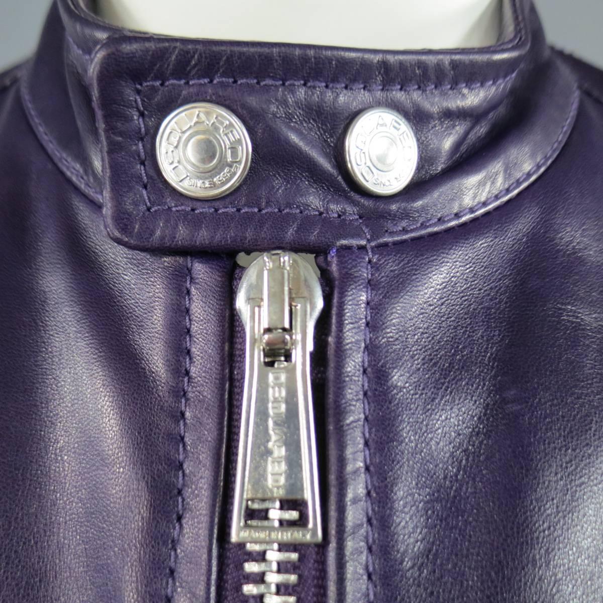 This ultra chic DSQUARED2 motorcycle jacket comes in a deep purple smooth leather and features a stand up band collar with silver tone snap closure, thick double zip closure, triple zip pockets, and snap cuffs with zip.
 
Excellent Pre-Owned