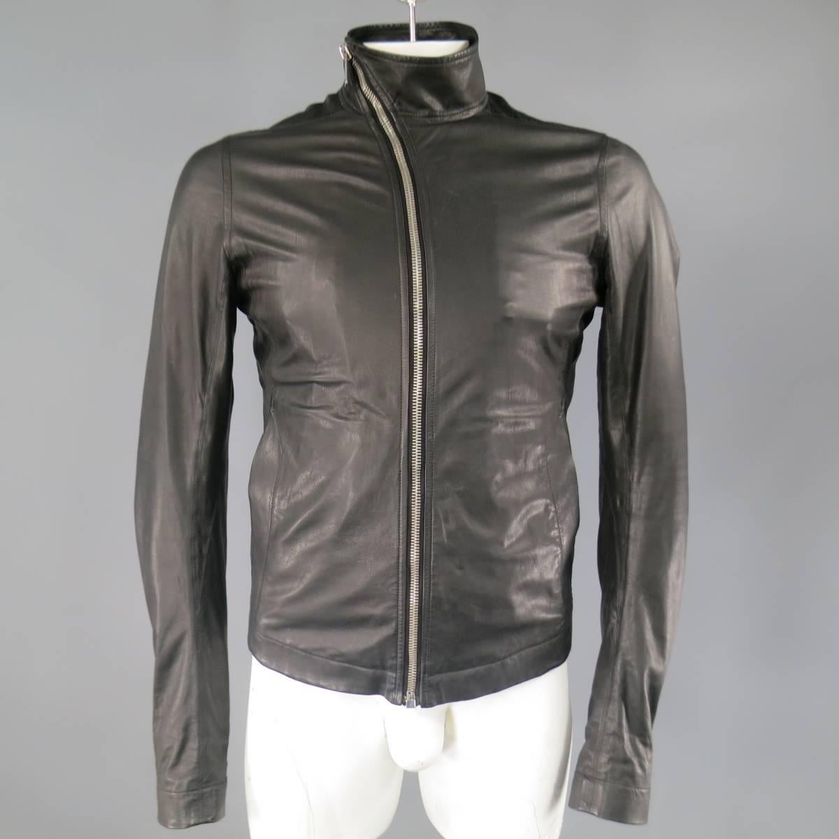 This classic RICK OWENS motorcycle jacket comes in an ultra soft, light weight black leather and features an asymmetrical slanted zip up front, high collar, tailored silhouette, double slit pockets, and zip cuff long sleeves. Made in Italy.
