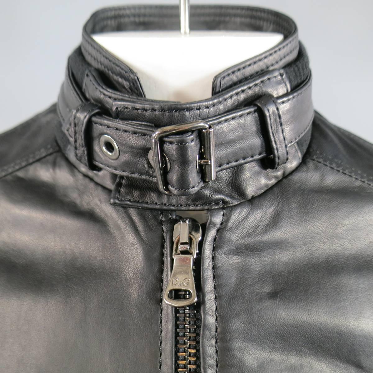 This chic D&G by DOLCE & GABBANA motorcycle jacket comes in a buttery soft black leather and features an oversized zip up front, symmetrical zip and patch flap snap pockets, paneled construction, ribbed zip cuffs, and layered ribbed stand up collar