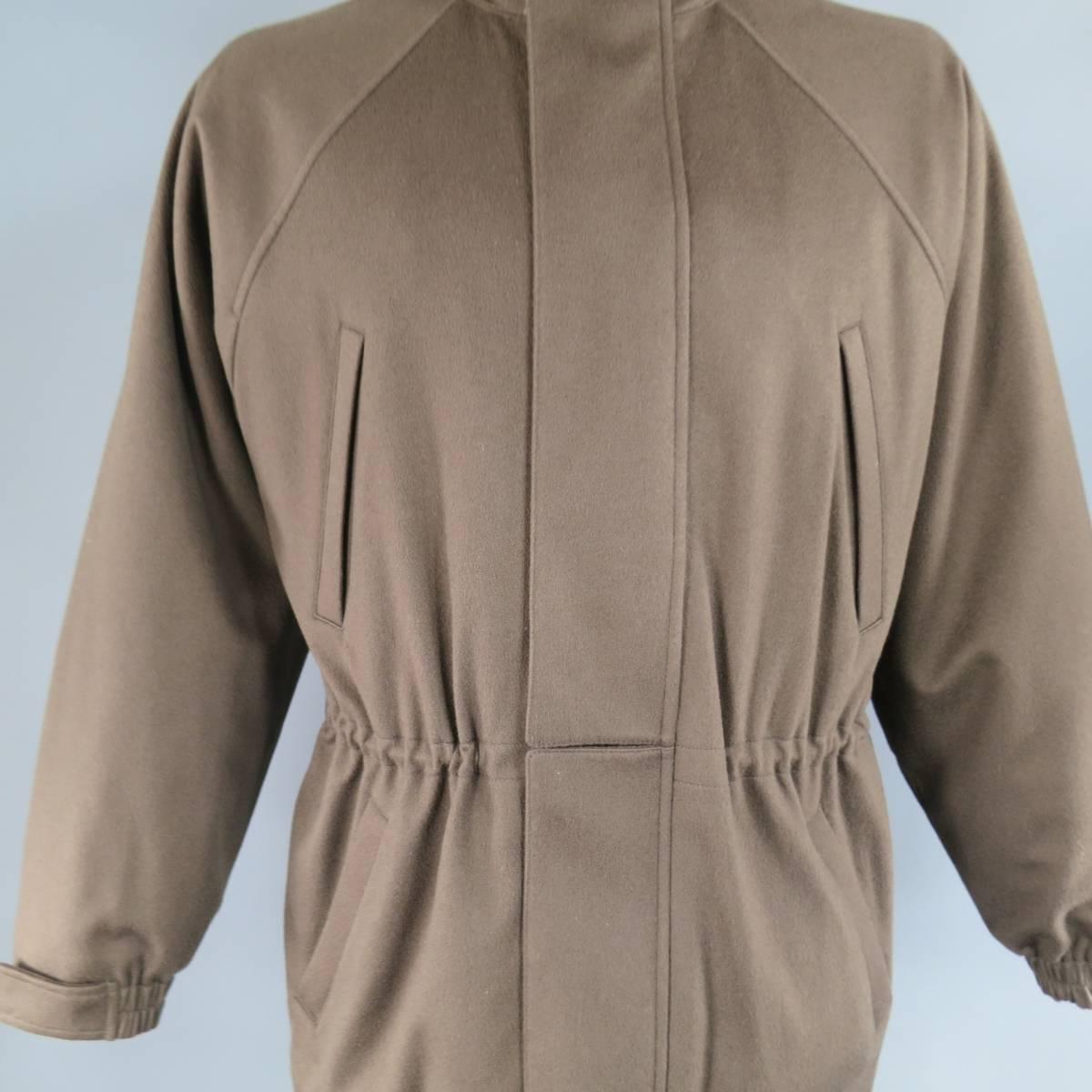 This classic LORO PIANA "Icer" ski coat comes in a soft brown cashmere felt and features a high collar, zip up front with hidden snap placket, drawstring waist, four slanted pockets, raglan sleeves with ribbed cuffs, and waterproof STORM