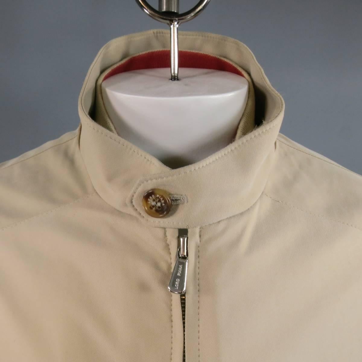 Classic LORO PIANA coat in khaki twill featuring a high neck with button tab, zip up front, slated zip pockets, button cuffs, embroidered tan suede neck decal, and detachable zip quilted vest. Made in Italy.
 
Excellent Pre-Owned Condition.
Marked