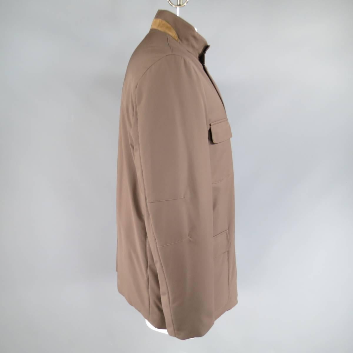 Classic winter coat by LORO PIANA in soft brown nylon twill featuring a high snap collar with tan embroidered suede back, zip and button up closure, four flap patch pockets, and heavy navy liner with ribbed cuffs. Made in Italy.
Retails at