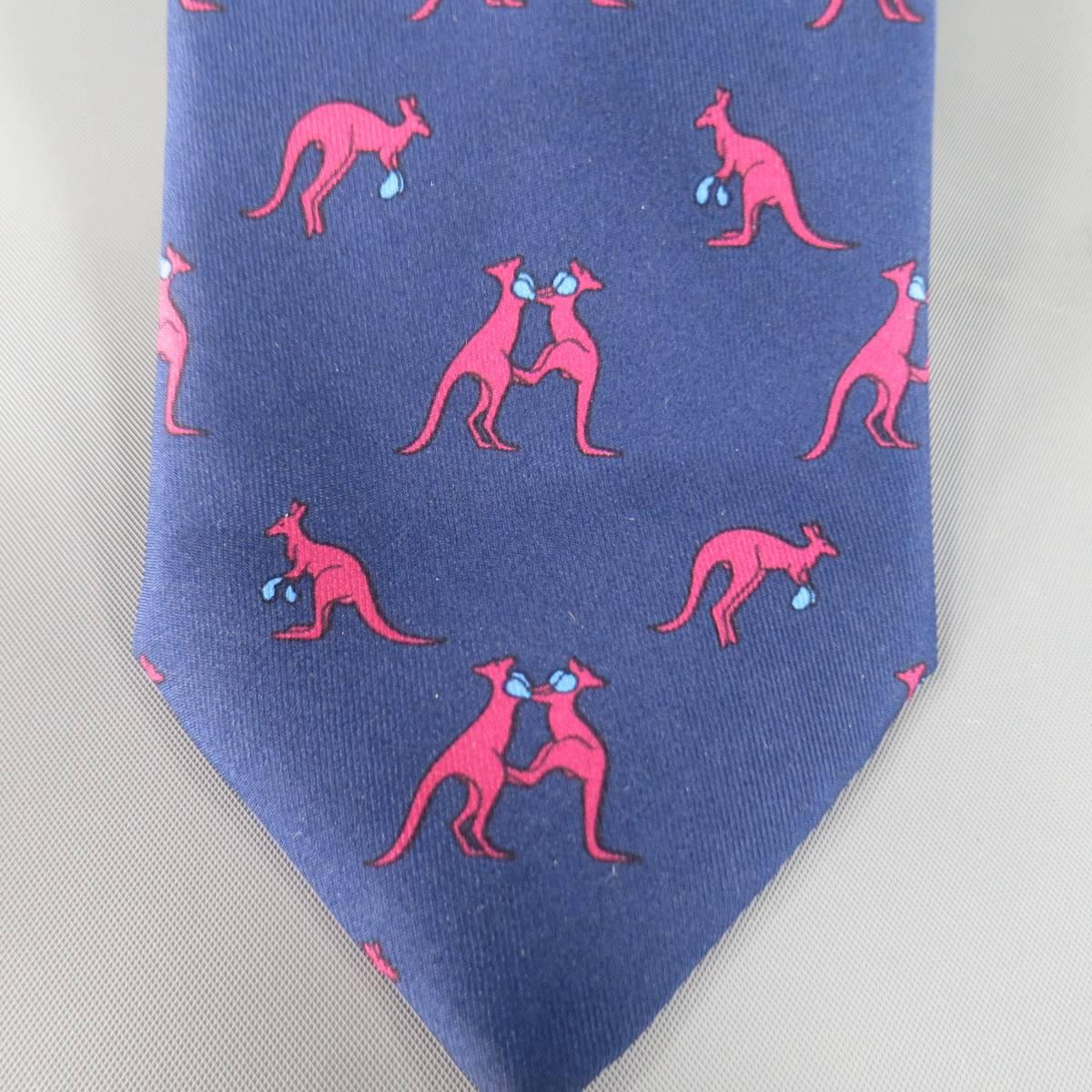 HERMES Tie consists of 100% silk material in a navy color tone. Designed in a slim contemporary style, graphic print throughout body. Detailed with boxing kangaroo's in red and light blue tones. Made in France.
 
Excellent Pre-Owned