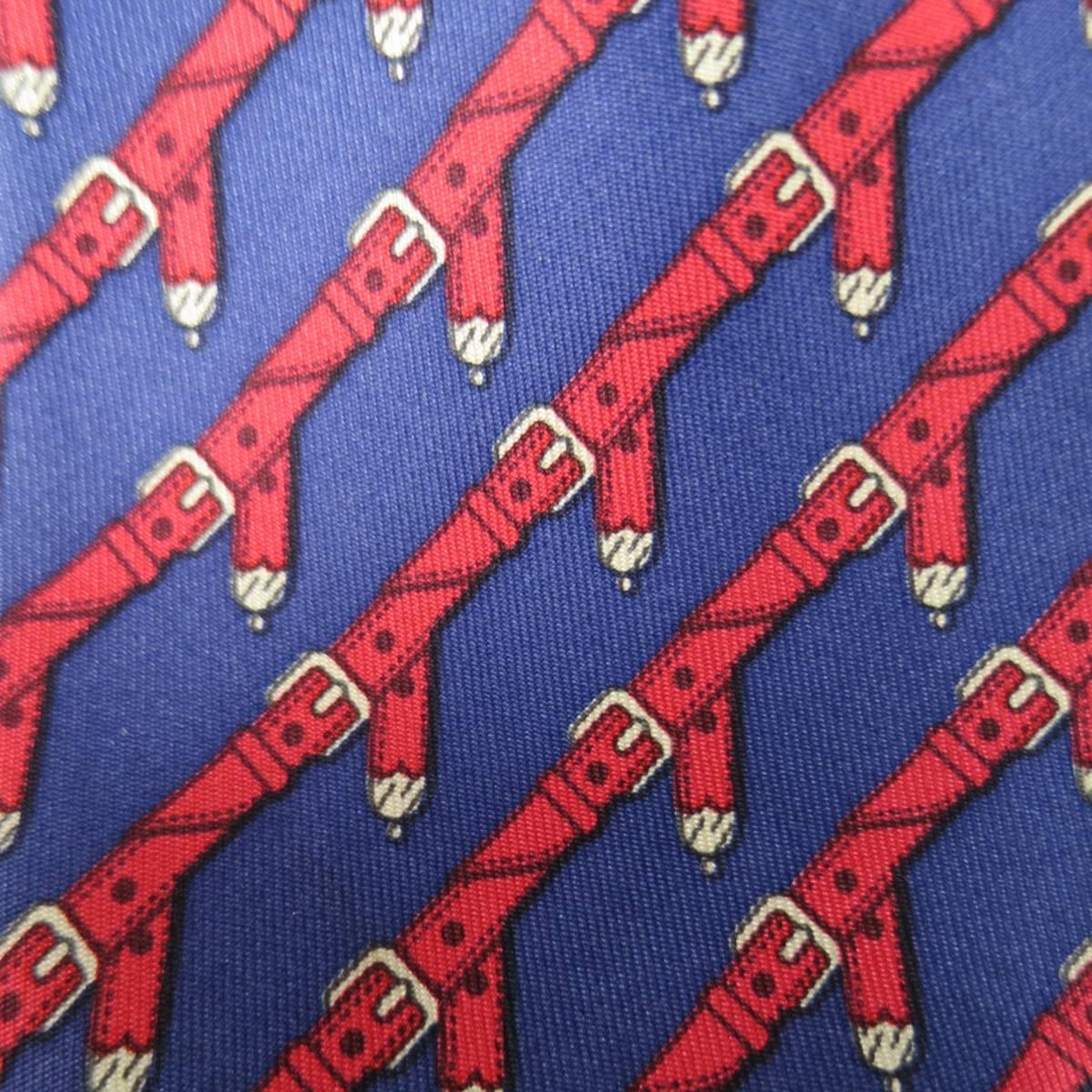 HERMES Tie consists of 100% silk material in a navy and red color tone. Designed in a slim contemporary style, diagonal belt buckle pattern throughout body with silver accents. Made in Italy.
 
Excellent Pre-Owned Condition
Marked: 954IA
