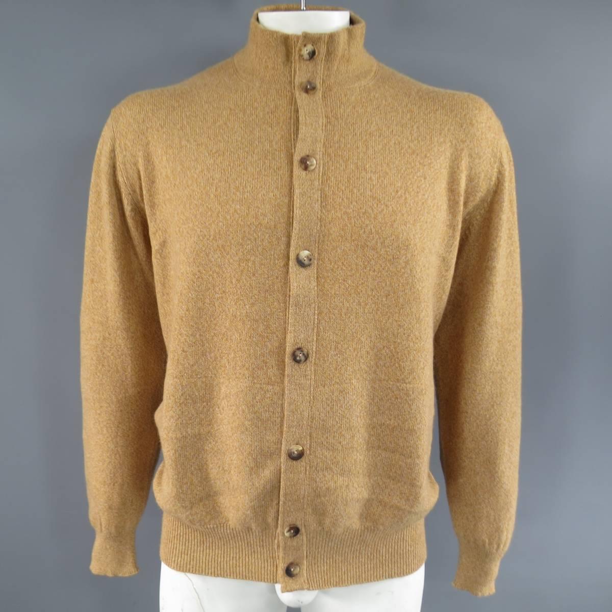 LORO PIANA Cardigan consists of 100% cashmere material in tan color tone. Designed in a high-collar style, button-up front, heather knit pattern throughout body. Detailed with rib cuff's and hem. Comes with original tag. Made in Italy.
Retails at