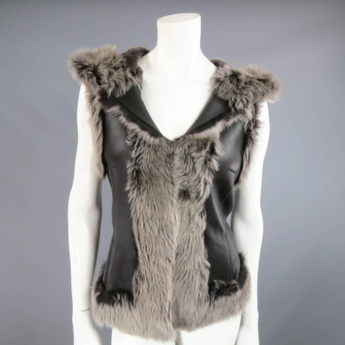 Gorgeous ROSENBERG & LENHART winter vest in black leather lamb shearling with gray fur featuring hook eye closures, side pockets, and a hood. Made in Germany.
 
Good Pre-Owned Condition.
Marked: FR 40
 
Measurements:
 
Shoulder: 15 in.
Bust: