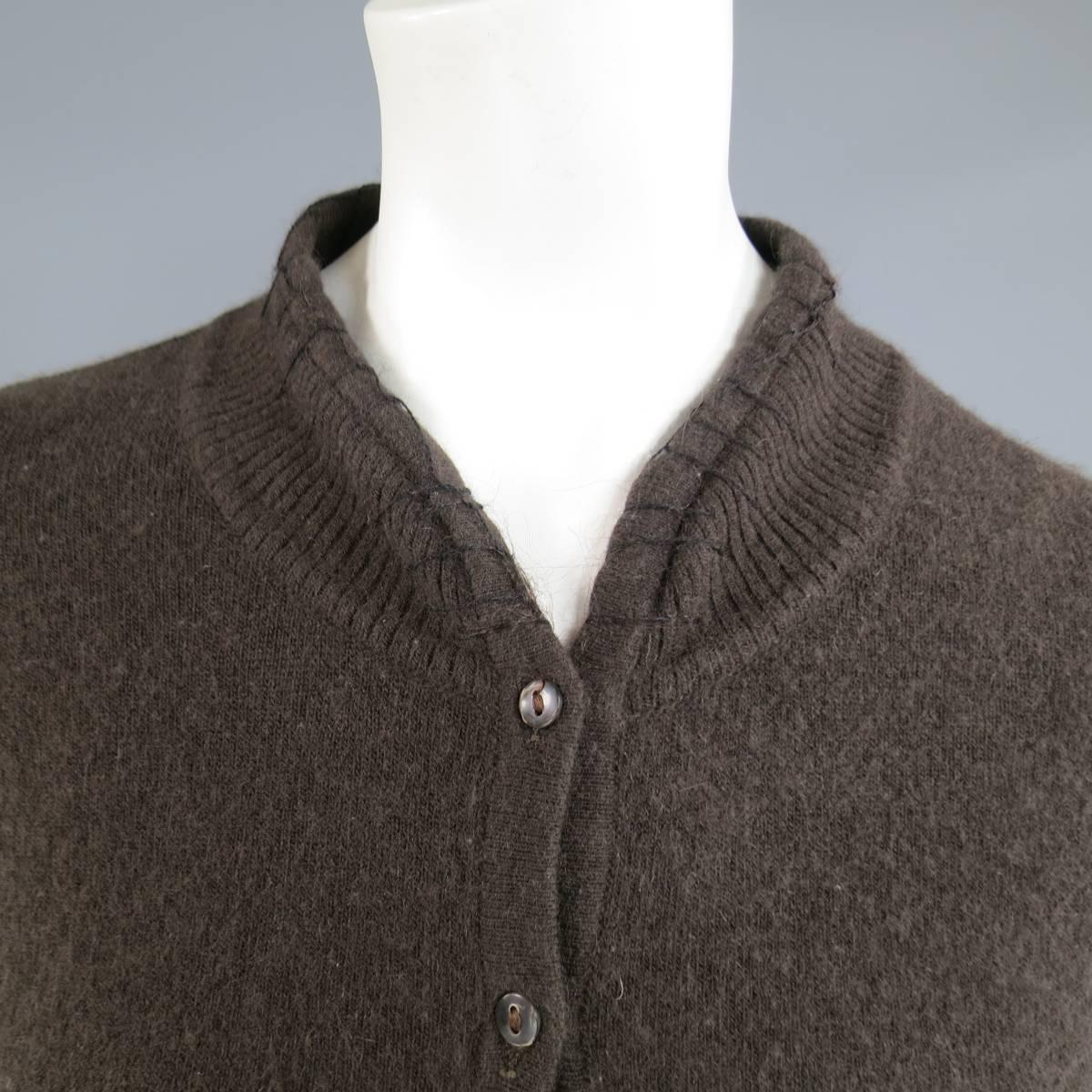 This rare JOHN GALLIANO cardigan comes in a soft brown angora blend knit and features a high collar with top stitch detail, embroidered cutout flowers, and extra long extended gathered sleeves. Made in Italy.
 
Good Pre-Owned Condition.
Marked: