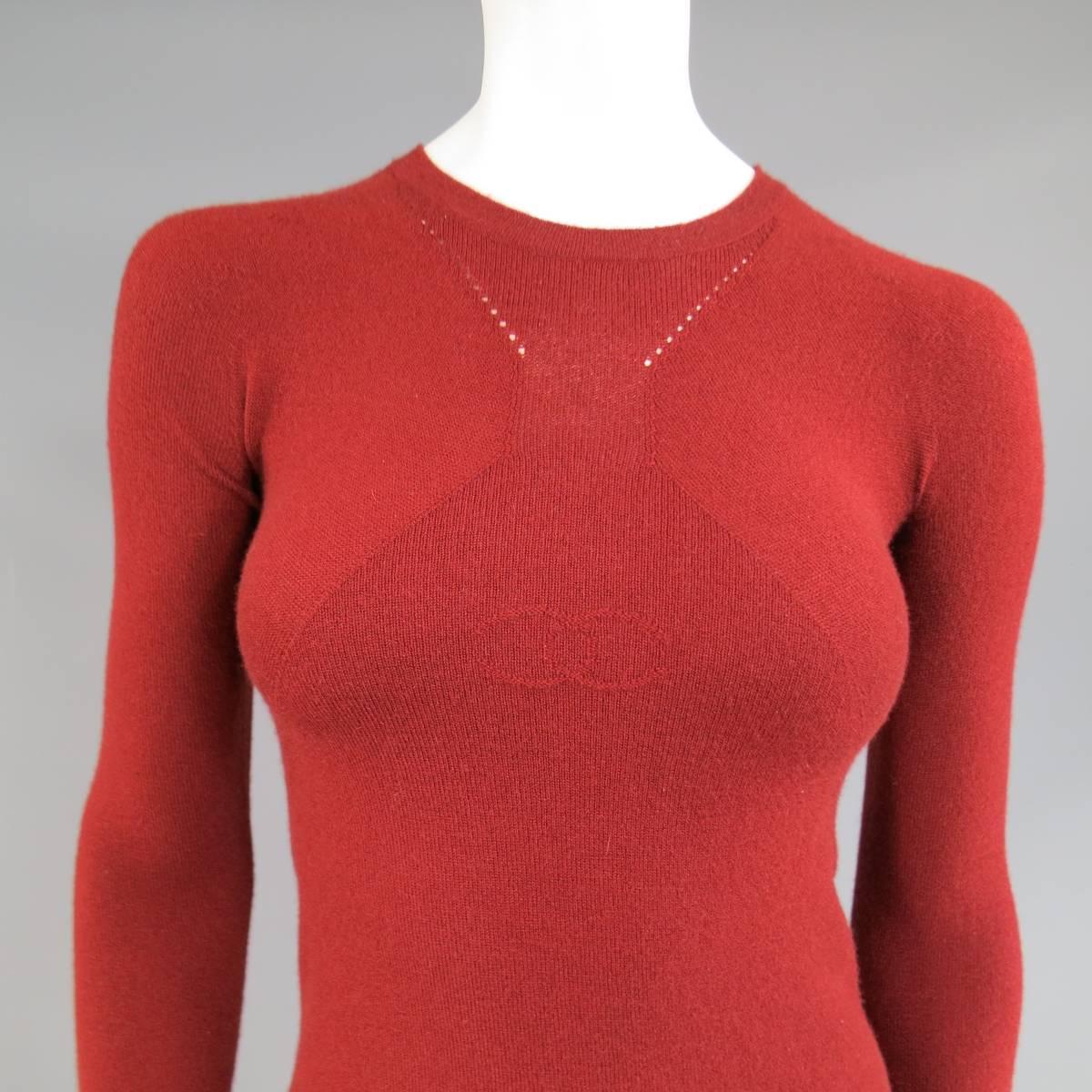 This unique CHANEL pullover sweater comes in rich brick red stretch cashmere blend and features a crewneck, symmetrical geometric sheer panels, and logo on the chest. Made in Italy. Fall / Winter 2006.
 
Excellent Good Pre-Owned