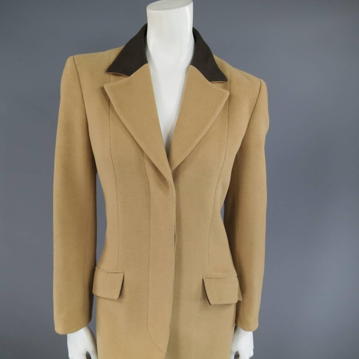 This chic VALENTINO Miss V coat comes in a tan camel Angora blend felt and features a two tone pointed lapel with brown collar, hidden placket button up closure, double slanted flap pockets, and single vented back. Made in Italy.
 
Excellent