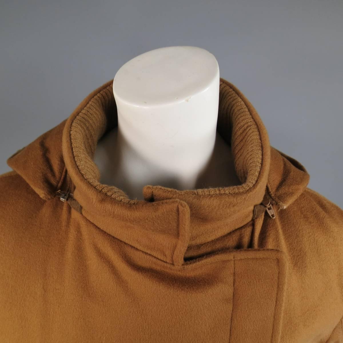 This classic LORO PIANA Storm System ski jacket comes in a a rich tan cashmere felt and features a high stand up snap collar with ribbed liner, detachable zip off hood, slit pockets, slanted hidden zip closure, and green satin padded liner. Made in