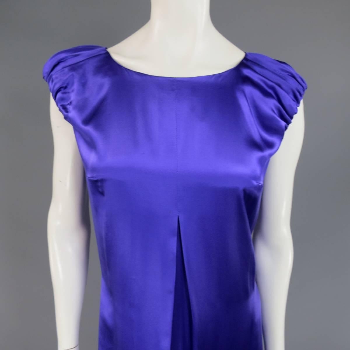 This gorgeous DOLCE & GABBANA cocktail dress comes in a purple silk satin and features an A line silhouette, pleated front, scoop neck, short gathered puff sleeves, and back zip closure. Small imperfection in detail shot. Made in Italy.
 
Good