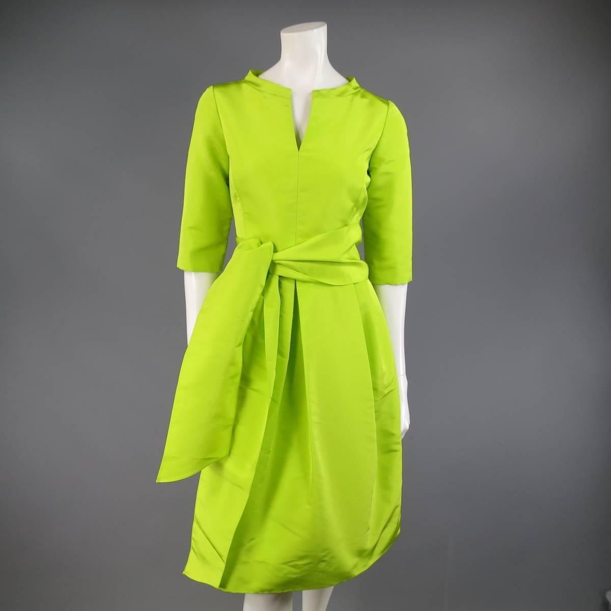 This fabulous LEE ANDERSON COUTURE cocktail dress comes in a bold lime green silk taffeta faille and features a scoop neck line with slit, three quarter sleeves, pleated A line skirt with slit pockets, and matching thick sash.
 
Excellent