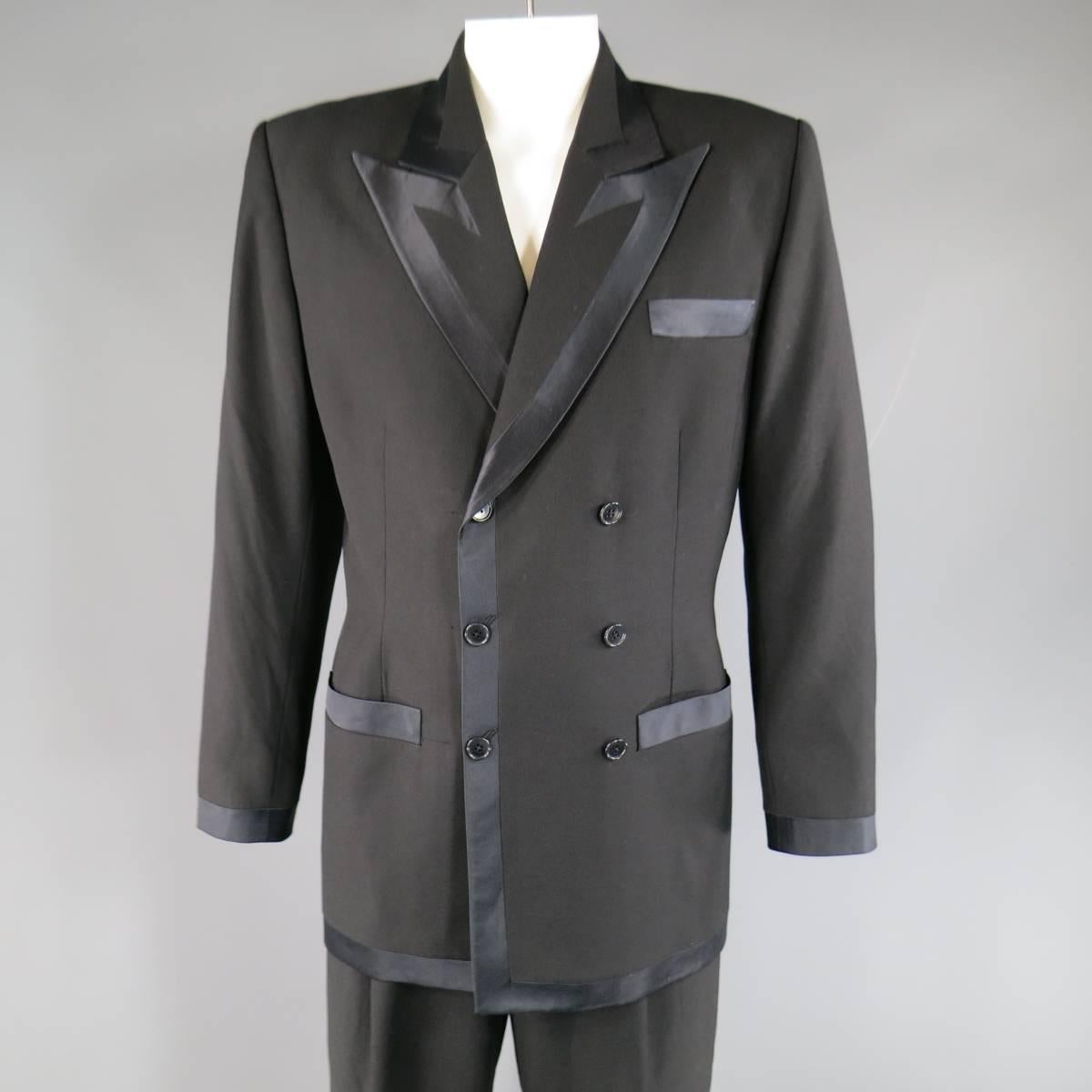 Vintage RICHARD TYLER tuxedo suit comes in a black wool fabric and includes a double breasted, peak lapel, silk lined sport coat with thick satin piping and matching high wasted, single pleat trousers with skinny satin piping stripe.Made in USA.

