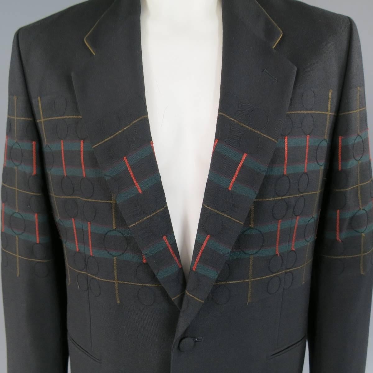 This vintage MATSUDA oversized sport coat comes in a medium weight black wool twill and features a large notch lapel with tan suede piping on the collar, two fabric covered button closure, double slip pockets, and tan, green, burgundy, and red