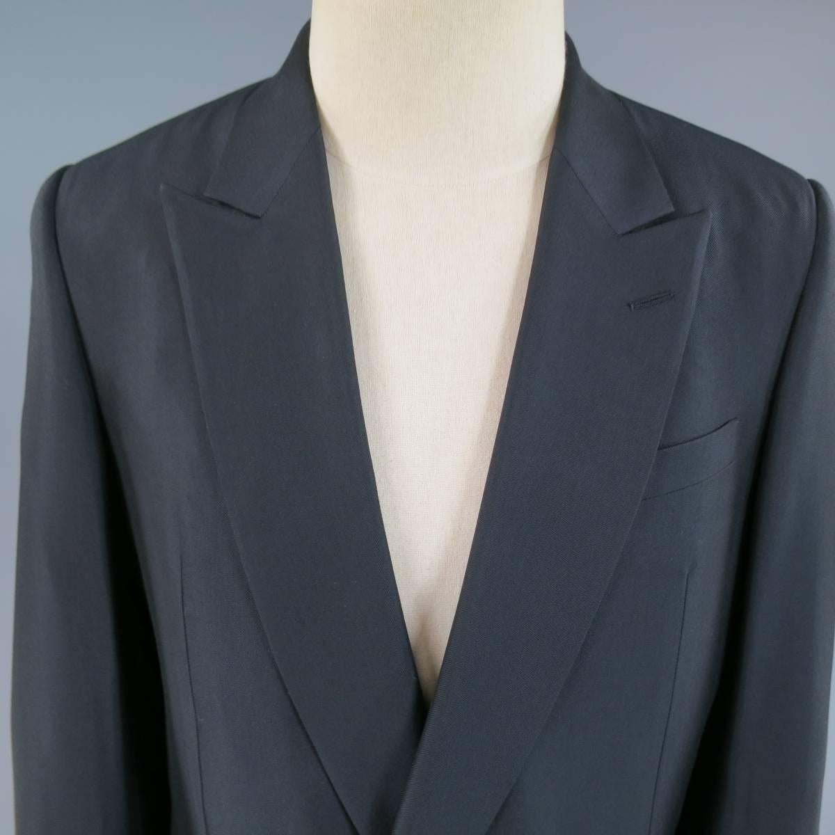 This chic BALENCIAGA double breasted sport coat comes in a deep midnight navy wool rayon blend twill with a sheen to it and features a pointed peak lapel, navy buttons, double flap pockets, and single vented back. Made in Italy.
Retails at