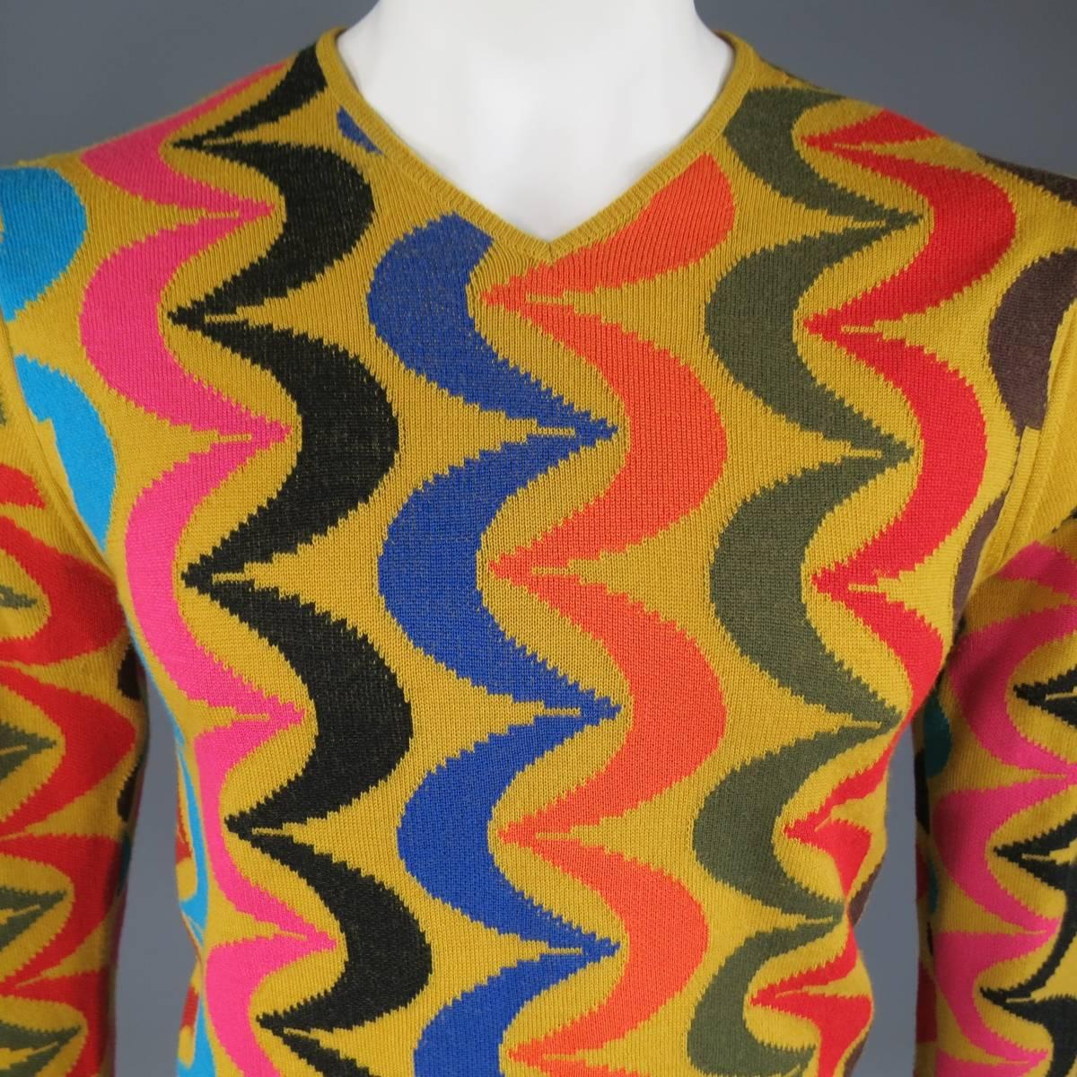 This rare COMME DES GARCONS HOMME PLUS V neck pullover sweater comes in a goldrod yellow wool blend knit with all over red, teal, pink, black, green, and brown curved stripe print. holes on shoulder. As-Is.Made in Japan.
 
Fair Pre-Owned
